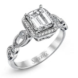 Reflecting a lovely romantic design, this white gold classic engagement ring features .16 ctw round cut white diamond accents.