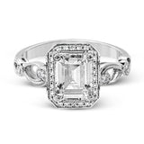 Reflecting a lovely romantic design, this white gold classic engagement ring features .16 ctw round cut white diamond accents.