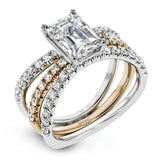This distinctive bridal set design features a double-layer wedding band that fits around the engagement ring. The set contains .77 ctw of white diamonds.