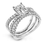 This distinctive bridal set design features a double-layer wedding band that fits around the engagement ring. The set contains .77 ctw of white diamonds.