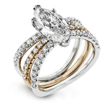 This distinctive bridal set design features a double-layer wedding band that fits around the engagement ring. The set contains .77 ctw of white diamonds.