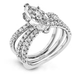 This distinctive bridal set design features a double-layer wedding band that fits around the engagement ring. The set contains .77 ctw of white diamonds.
