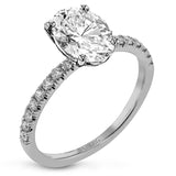This distinctive bridal set design features a double-layer wedding band that fits around the engagement ring. The set contains .77 ctw of white diamonds.