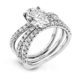 This distinctive bridal set design features a double-layer wedding band that fits around the engagement ring. The set contains .77 ctw of white diamonds.