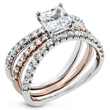 This distinctive bridal set design features a double-layer wedding band that fits around the engagement ring. The set contains .77 ctw of white diamonds.