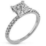 This distinctive bridal set design features a double-layer wedding band that fits around the engagement ring. The set contains .77 ctw of white diamonds.