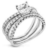 This distinctive bridal set design features a double-layer wedding band that fits around the engagement ring. The set contains .77 ctw of white diamonds.