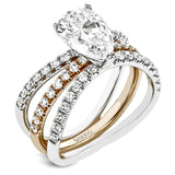 This distinctive bridal set design features a double-layer wedding band that fits around the engagement ring. The set contains .77 ctw of white diamonds.