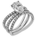 This distinctive bridal set design features a double-layer wedding band that fits around the engagement ring. The set contains .77 ctw of white diamonds.
