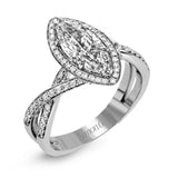 This sparkling modern engagement ring features an eye-catching twisted design with elegant classic halo accented by .29 ctw of shimmering round cut white diamonds.