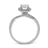 This sparkling modern engagement ring features an eye-catching twisted design with elegant classic halo accented by .29 ctw of shimmering round cut white diamonds.