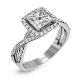 This sparkling modern engagement ring features an eye-catching twisted design with elegant classic halo accented by .29 ctw of shimmering round cut white diamonds.