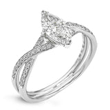 This sparkling modern white gold engagement ring and wedding band set features an eye-catching twisted design accented by .22 ctw of shimmering round cut white diamonds.