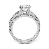 The intricate twisted design of this modern white gold engagement ring and wedding band set is set with .65 ctw of striking round cut white diamonds.