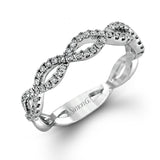 The intricate twisted design of this modern white gold engagement ring and wedding band set is set with .65 ctw of striking round cut white diamonds.