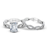 The intricate twisted design of this modern white gold engagement ring and wedding band set is set with .65 ctw of striking round cut white diamonds.