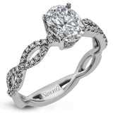 The intricate twisted design of this modern white gold engagement ring and wedding band set is set with .65 ctw of striking round cut white diamonds.