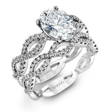The intricate twisted design of this modern white gold engagement ring and wedding band set is set with .65 ctw of striking round cut white diamonds.
