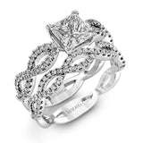 The intricate twisted design of this modern white gold engagement ring and wedding band set is set with .65 ctw of striking round cut white diamonds.