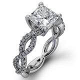 The intricate twisted design of this modern white gold engagement ring and wedding band set is set with .65 ctw of striking round cut white diamonds.