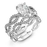 The intricate twisted design of this modern white gold engagement ring and wedding band set is set with .65 ctw of striking round cut white diamonds.