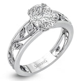A delicate floral design highlights this vintage style engagement ring accented by .09 ctw of shimmering round cut white diamonds.