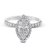 This elegant classic white gold halo engagement ring and band is set with .78 ctw of sparkling round cut white diamonds.