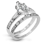 This dazzling white gold wedding set is enhanced by .21 ctw round cut white diamonds with side accents of .53 ctw of baguette cut diamonds.