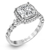 The delicate design of this classic white gold engagement ring features a sparkling pave halo accented with .86 ctw of shimmering round cut white diamonds.