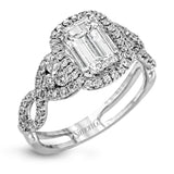 Reflecting an intricate modern design, this remarkable white gold ring is emphasized by a lovely halo complemented with .59 ctw round cut white diamonds.