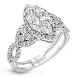 Reflecting an intricate modern design, this remarkable white gold ring is emphasized by a lovely halo complemented with .59 ctw round cut white diamonds.