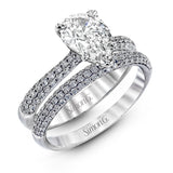 The classic design of this white gold engagement ring and wedding band set is emphasized by .72 ctw round cut white diamonds.