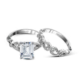 This delicate floral inspired white gold engagement ring and wedding band set is accentuated with .28 ctw shimmering round cut white diamonds.