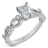 This delicate floral inspired white gold engagement ring and wedding band set is accentuated with .28 ctw shimmering round cut white diamonds.