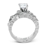 This delicate floral inspired white gold engagement ring and wedding band set is accentuated with .28 ctw shimmering round cut white diamonds.