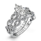 This delicate floral inspired white gold engagement ring and wedding band set is accentuated with .28 ctw shimmering round cut white diamonds.