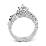 This delicate floral inspired white gold engagement ring and wedding band set is accentuated with .28 ctw shimmering round cut white diamonds.