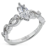 This delicate floral inspired white gold engagement ring and wedding band set is accentuated with .28 ctw shimmering round cut white diamonds.