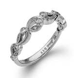 This delicate floral inspired white gold engagement ring and wedding band set is accentuated with .28 ctw shimmering round cut white diamonds.