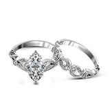 This delicate floral inspired white gold engagement ring and wedding band set is accentuated with .28 ctw shimmering round cut white diamonds.