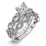 This delicate floral inspired white gold engagement ring and wedding band set is accentuated with .28 ctw shimmering round cut white diamonds.