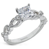 This delicate floral inspired white gold engagement ring and wedding band set is accentuated with .28 ctw shimmering round cut white diamonds.