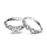 This delicate floral inspired white gold engagement ring and wedding band set is accentuated with .28 ctw shimmering round cut white diamonds.