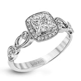 Reflecting a lovely romantic design, this white gold classic engagement ring features .16 ctw round cut white diamond accents.