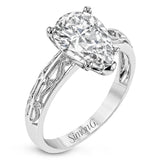 A whimsical openwork design glimmers with .04 ctw of round white diamonds in this charmingly beautiful white gold engagement ring.