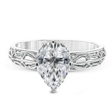 A whimsical openwork design glimmers with .04 ctw of round white diamonds in this charmingly beautiful white gold engagement ring.