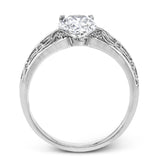 A whimsical openwork design glimmers with .04 ctw of round white diamonds in this charmingly beautiful white gold engagement ring.