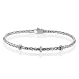 This easy-to-wear bracelet features three white gold stations set with .10ctw of diamonds set in a woven braid of 18k white gold.