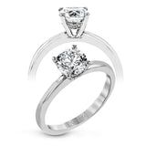 This singular engagement accents the center stone with a touch of .03 ctw of diamonds around the secure basket setting, while the band shines in high polish metal.