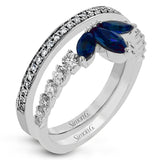 This 18k white gold ring creates the look of two rings in one, with a center design of .66 ctw of sapphires accented by .61 ctw of white diamonds.